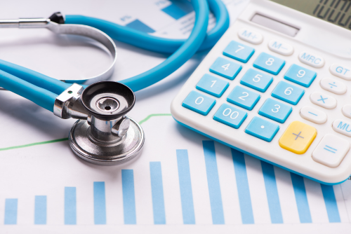 Stethoscope and calculator on a table