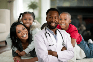 Happy family with a smiling competent doctor