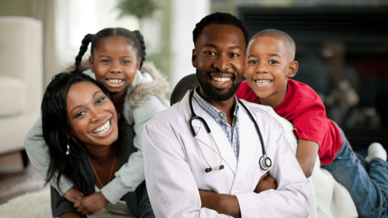 Happy family with a smiling competent doctor